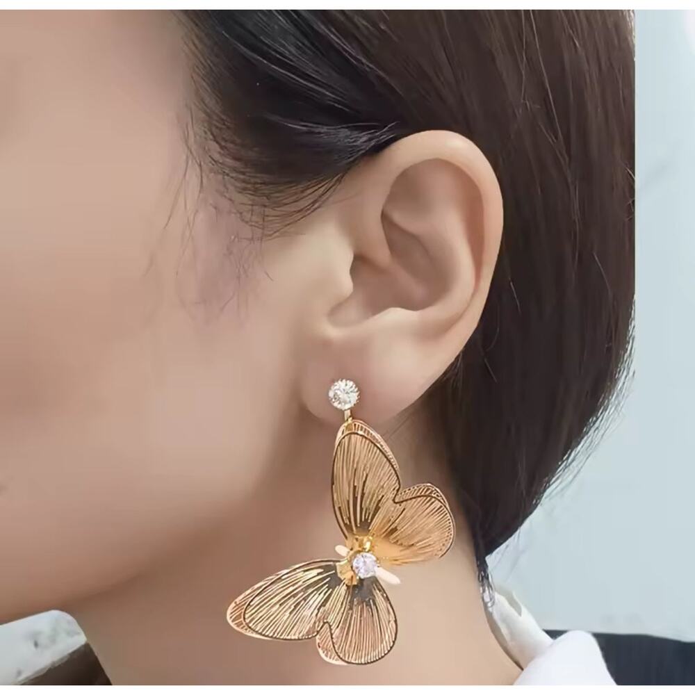 Clip on 2 1/2" gold cutout dangle butterfly earrings with clear stone